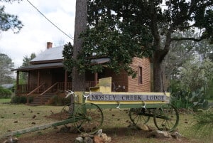 Mossey Creek Outdoors Lodging Cabin Front Porch View and Entrance Sign